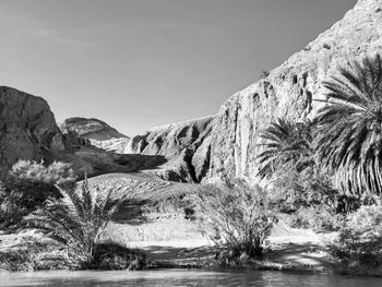 Scenic view of river amidst mountains against sky
