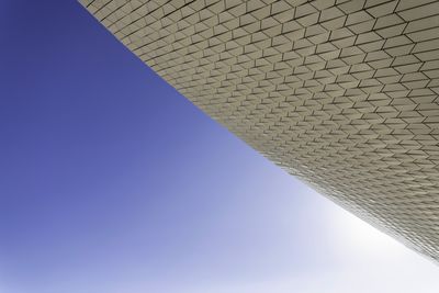 Low angle view of modern building against blue sky