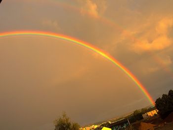 Low angle view of rainbow against sky at sunset