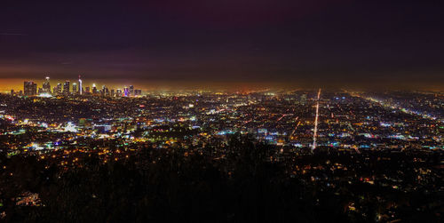 High angle view of city lit up at night