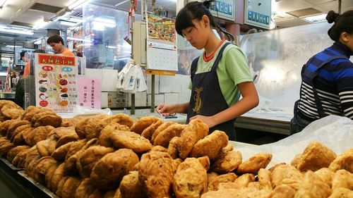 Woman working at market stall