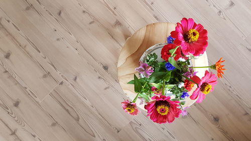 High angle view of pink flower bouquet on hardwood floor