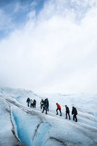 People climbing a glacier