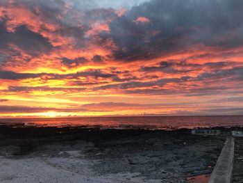 Scenic view of sea against orange sky