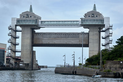 View of bridge over river against buildings