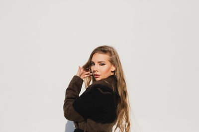 Portrait of a beautiful young woman over white background