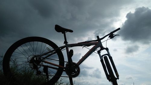 Low angle view of silhouette bicycle against sky