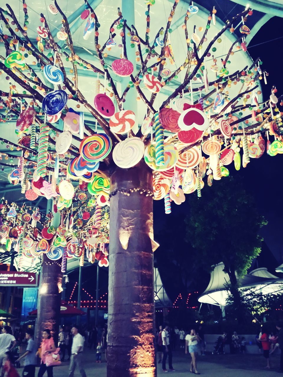 large group of people, person, men, built structure, architecture, lifestyles, illuminated, leisure activity, tree, low angle view, night, cultures, religion, mixed age range, crowd, celebration, tradition, decoration, spirituality