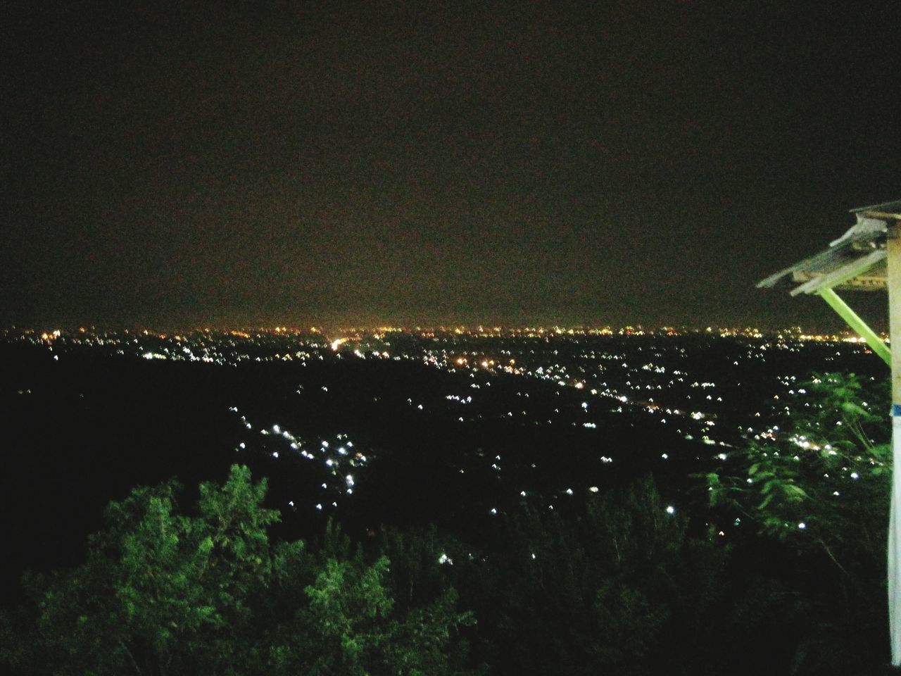 night, illuminated, city, cityscape, architecture, building exterior, built structure, high angle view, copy space, clear sky, crowded, tree, dark, aerial view, residential district, sky, outdoors, no people, residential building, city life