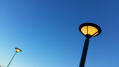 Low angle view of street light against clear blue sky