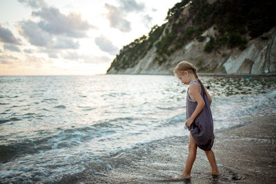 Side view of boy on beach