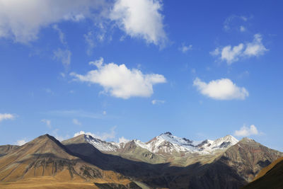 Panoramic view of snowcapped mountains against sky