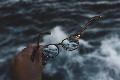 Close-up of hand holding glasses