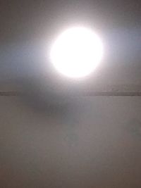 Low angle view of illuminated light on ceiling