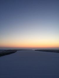 Scenic view of sea against clear sky during sunset