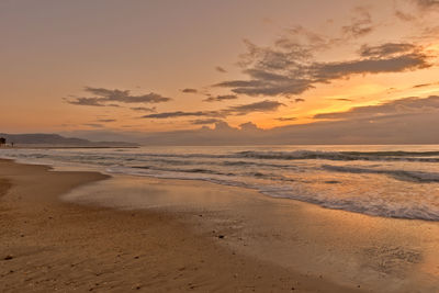 Scenic view of beach against sky during sunset