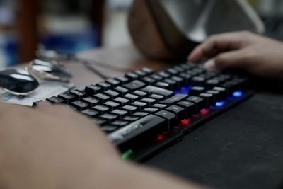 Close-up of person using mobile phone on table