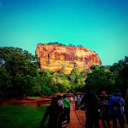 People at observation point against clear sky