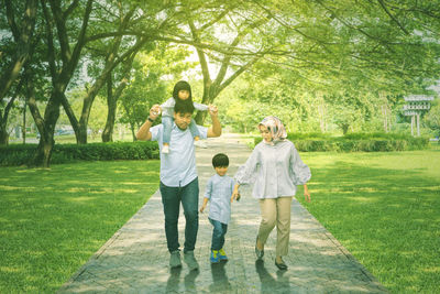 Cheerful family walking at park