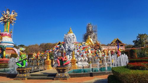 Statue of temple against building