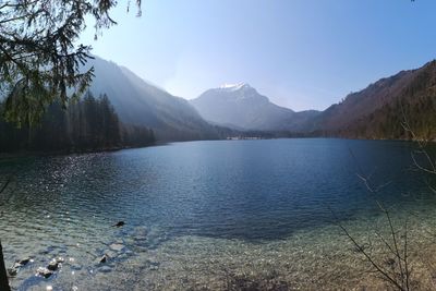 Scenic view of lake and mountains against sky