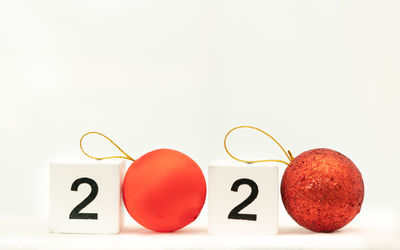 Close-up of red fruits over white background