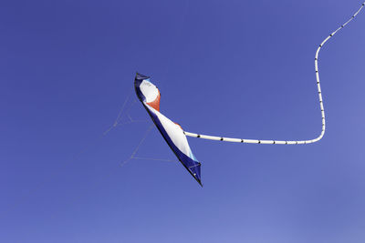 Low angle view of kite against clear blue sky