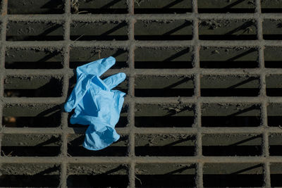 Close-up of blue metal against wall