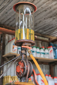 Low angle view of electric lamp hanging in factory