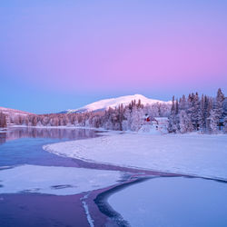 Scenic view of frozen lake against clear sky during winter