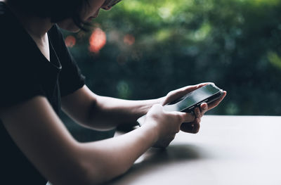 Midsection of man using mobile phone