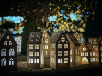 Low angle view of illuminated buildings in city at night