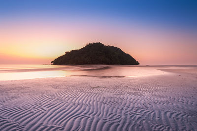 Scenic view of sea against clear sky during sunset
