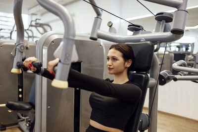 Midsection of woman exercising in gym