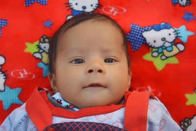 Portrait of cute baby girl lying down