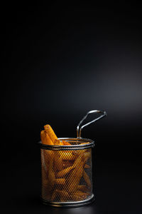 Close-up of drink in container against black background