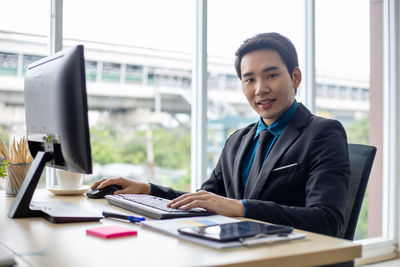 Portrait of man working on table