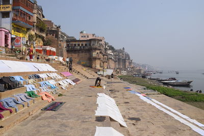 People on street against buildings in city