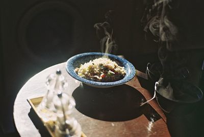 High angle view of food served in bowl on wooden table