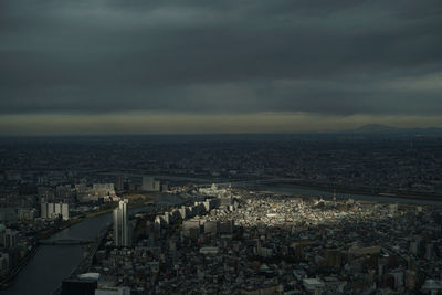 Aerial view of buildings in city at dusk