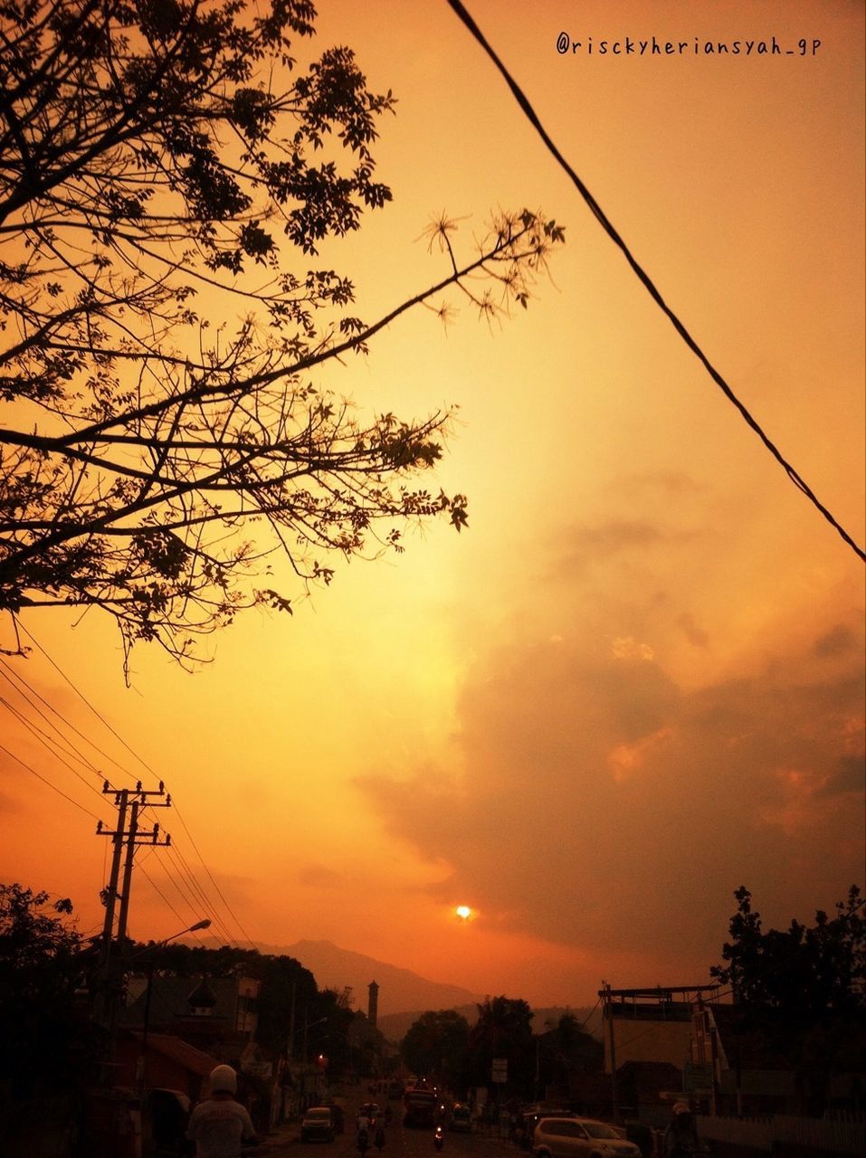 sunset, building exterior, architecture, built structure, sky, tree, power line, silhouette, orange color, cloud - sky, low angle view, house, street light, electricity pylon, cable, residential structure, town, city, residential building, nature