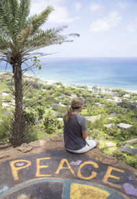 Rear view of woman looking at sea against sky