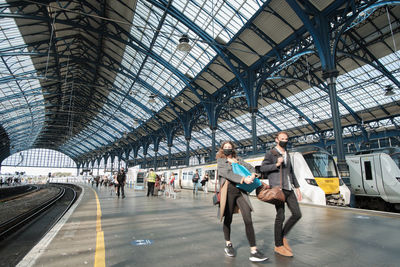 Group of people walking at railroad station