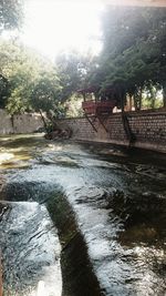 Reflection of trees in river during rainy season