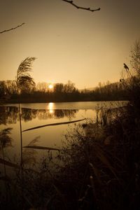 Scenic view of lake against sky during sunset