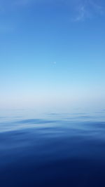 Scenic view of sea against blue sky