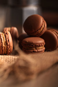There are some delicious chocolate and cocoa flavored macaron desserts on the plate