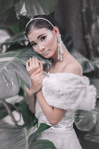 Portrait of a smiling young woman holding outdoors