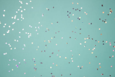 Low angle view of balloons against clear blue sky