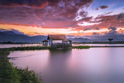 Scenic view of lake against sky during sunset